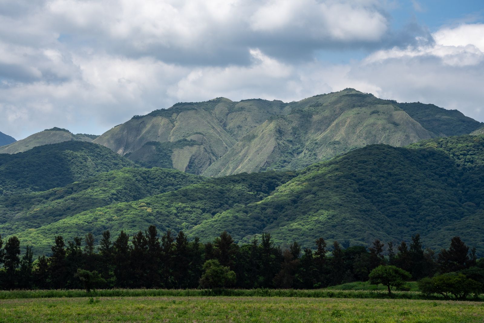 Central park and parish church in the hillside town of La Paz, Honduras, with the Comayagua valley behind